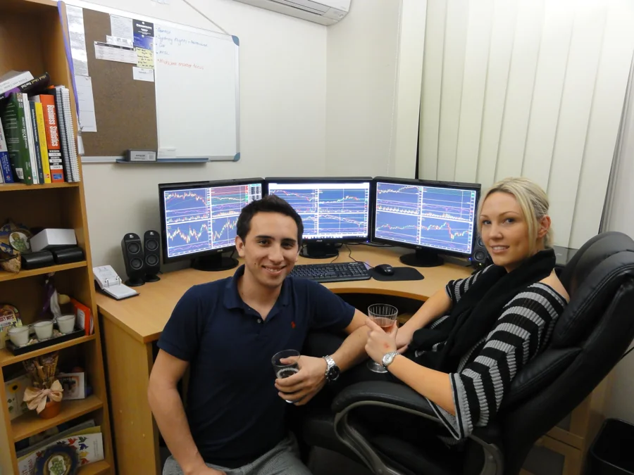 Lewis in the first Infinite Prosperity office in 2012, at a desk of trading screens