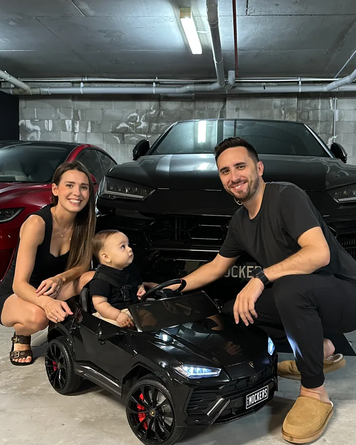 Lewis, Robyn and Lex in his toy Lamborghini Urus, in front of the real one