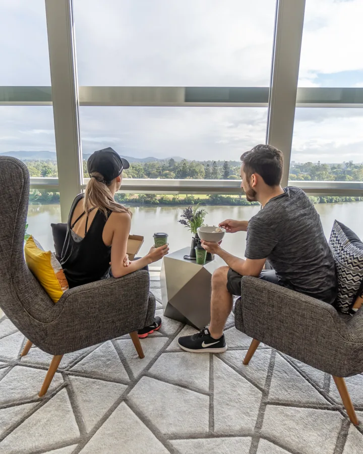 Lewis and Robyn looking out over the river from their apartment