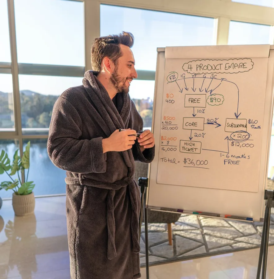 Lewis teaching at a whiteboard in his dressing gown